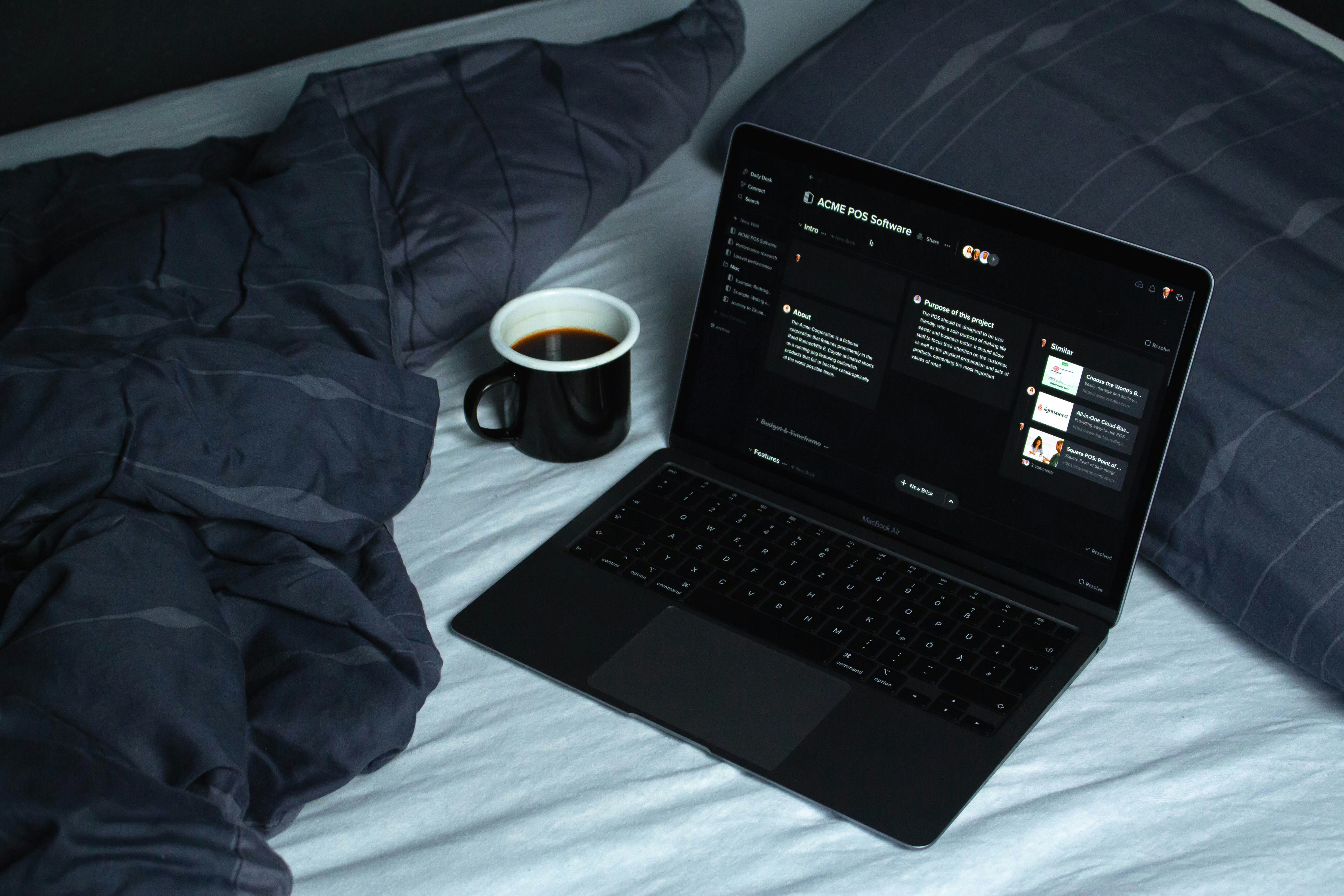 A lit monitor showing code in a dark home office